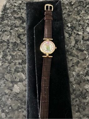 Gold Tone Round Watch with Brown Leather Strap and Playful Character Dial